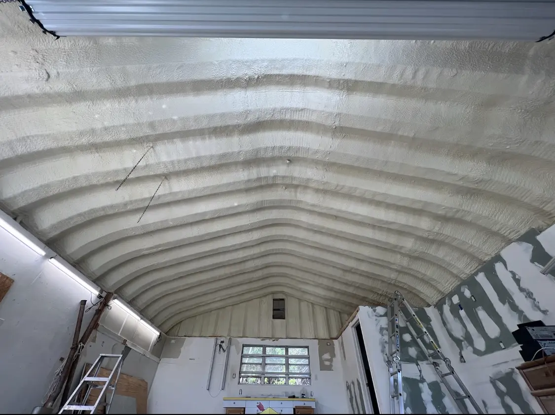 Spray polyurethane foam applied to the underside of a metal roof deck in Reminderville